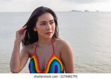 Young Asian Beautiful Woman In Bikini Looking Sexy. Hair Blowing In Wind On Tropical Beach In Summer Weather. Travel And Lifestyle Concept