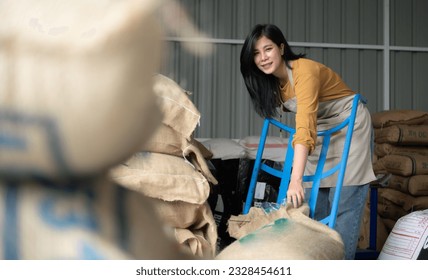 Young asian beautiful woman in coffee green bean bag factory, Happiness and confident in coffee industrial business and job success concept - Powered by Shutterstock