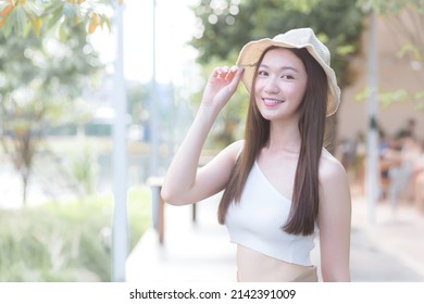 Young Asian Beautiful Woman With  Good Skin In Cream Shirt Standing Smiling Happily On Blurred Background.