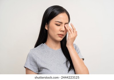 Young asian beautiful woman hand rubbing eyes she's feeling depressed stress headache be tired from working standing on isolated white background she has unwell unhealthy problems. - Powered by Shutterstock