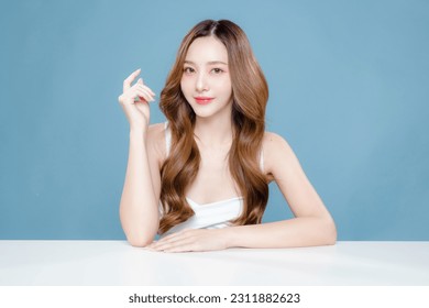 Young Asian beauty woman curly long hair with korean makeup style on face and perfect clean skin on isolated blue background. Facial treatment, Cosmetology, plastic surgery. - Powered by Shutterstock