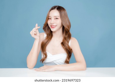 Young Asian beauty woman curly long hair with korean makeup style on face and perfect clean skin showing Love sign on isolated blue background. Facial treatment, Cosmetology, plastic surgery. - Powered by Shutterstock