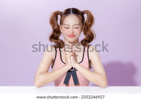 Young Asian beauty woman model pigtail hairstyle with cute makeup on face and perfect clean skin on isolated purple background. Facial treatment, Cosmetology, Aesthetic, plastic surgery.