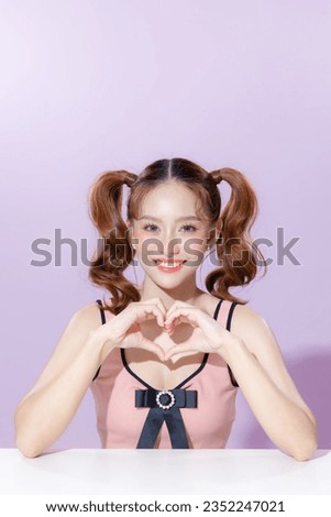 Young Asian beauty woman model pigtail hairstyle with cute makeup on face and perfect clean skin on isolated purple background. Facial treatment, Cosmetology, Aesthetic, plastic surgery.