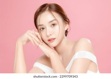 Young Asian beauty woman pulled back hair with korean makeup style on face and perfect skin on isolated pink background. Facial treatment, Cosmetology, plastic surgery.