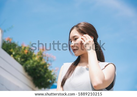 Young asian beauty woman in sunlight outdoors. UV lotion protection concept.