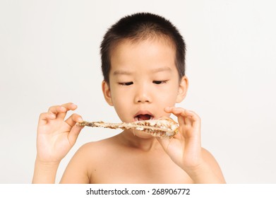 Young Asian Boy Eating Fish Showing Bone On White Background