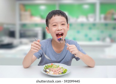 Young Asian Boy Eating Vegetables Salad