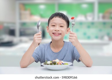 Young Asian Boy Eating Vegetables Salad