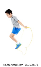 Young Asian Boy Exercise With Yellow Rubber Rope Jumping On White Background