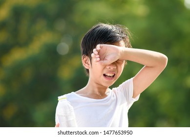 Young Asian Boy Feel Hot And Get Sweat In A Summer Day In A Park