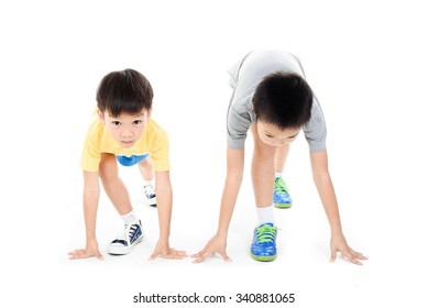 Young Asian Boy Prepare To Start Running Race On White Background