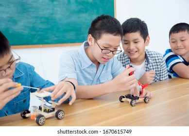 Young asian boy studying in science classroom,making electric remote control car.  - Powered by Shutterstock