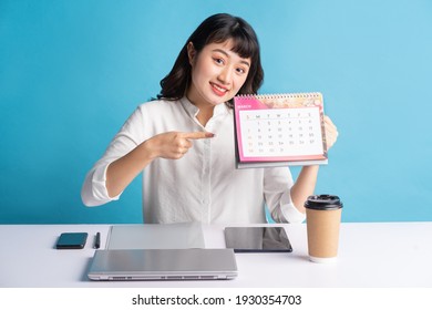 Young Asian Buisness Woman Working On Blue Background