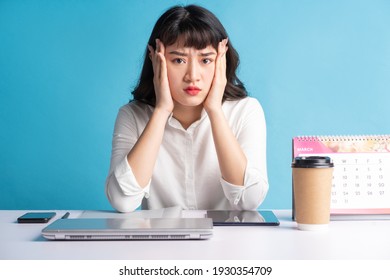 Young Asian Buisness Woman Working On Blue Background