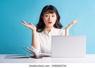 Young Asian Buisness Woman Working On Blue Background