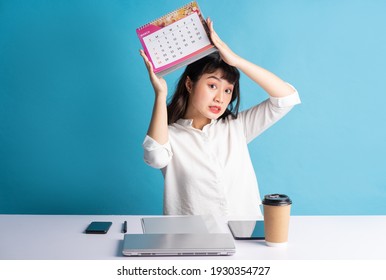 Young Asian Buisness Woman Working On Blue Background