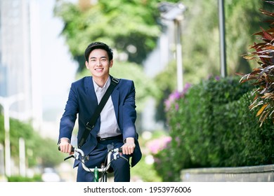 young asian business executive commuting by bike happy and smiling