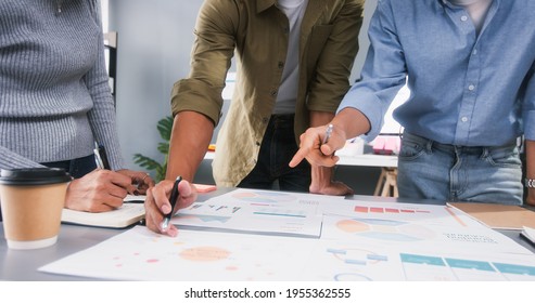 Young Asian business financial team work together in project brainstorm meeting. Cooperate teamwork, strategy planning, small business startup company, or office coworker collaborate concept - Powered by Shutterstock