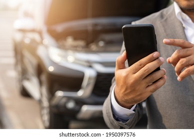 Young Asian Business Has Broken Down Car. He Open Hood And Check The Engine. He Using Smartphone Call For Help And Service. Car Broken On The Side Of The Road