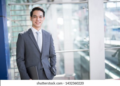 Young Asian Business Man Holding A Tablet 