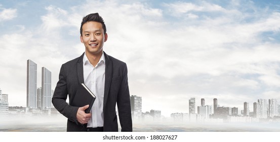 Young Asian Business Man Holding A Book