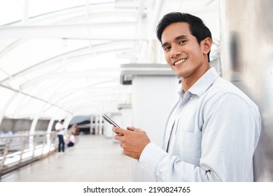 Young Asian Business Man Smile Holding Smart Phone At Middle Of Cityscape Area,man Smart Business Concept.