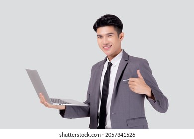 Young Asian Business Man Standing Work On Laptop Computer To Internet Online Isolated On White Background, Businessman Confident And Notebook, Freelance With Success, Marketing And Communication.