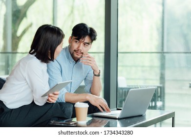 Young Asian business man and woman - Shutterstock ID 1734343280