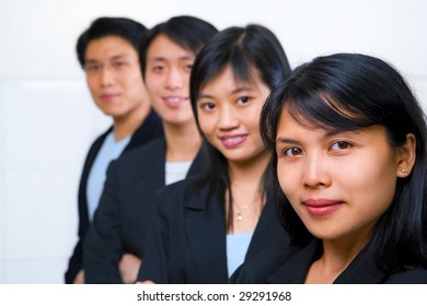 Young Asian Business People Line Up, With Focus On The Front Woman (South East Asian Woman)