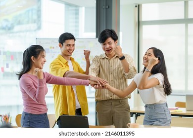 Young Asian Business People Putting Their Hands Together. Stack Of Hands And Together Working On New Startup Project. Unity And Teamwork Concept.