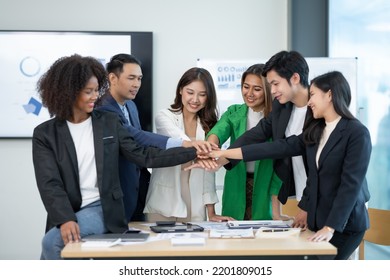 Young Asian Business People Shaking Hands To Agree To Work Towards The Same Goal And Work Together As A Team On A New Start-up Project. Unity And Teamwork Concept