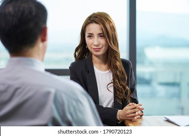 young asian business woman being interviewed by hr manager in modern corporate office