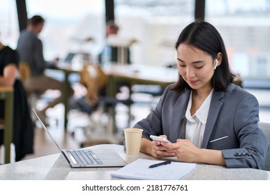 Young Asian Business Woman Entrepreneur Wearing Suit Working In Modern Office Holding Smartphone. Female Manager,professional Employee Using Mobile Apps On Cell Phone Watching Webinar At Work. Banner 