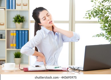 Young Asian Business Woman With Pain In Neck In Office