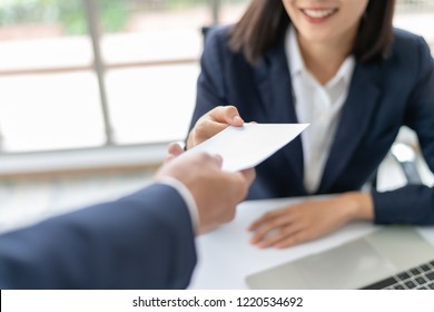 Young Asian business woman receiving salary or bonus money from boss or manager at office happily. - Shutterstock ID 1220534692