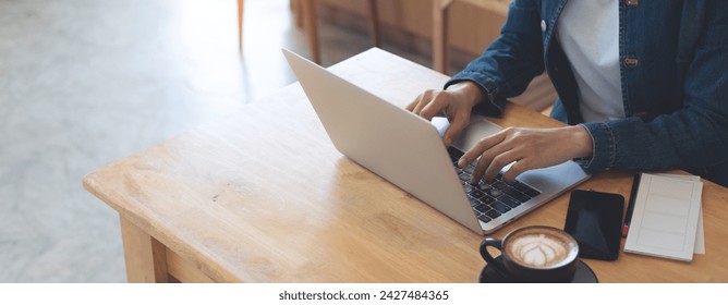 Young asian business woman working on laptop computer in coffee shop, freelance at work. Businesswoman in casual wear online working, typing on laptop, surfing the internet at cafe, remote work - Powered by Shutterstock