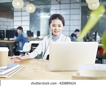 Young Asian Business Woman Working In Office Using Laptop Computer.