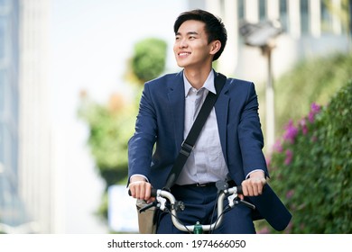 Young Asian Businessman Commuting By Bike Happy And Smiling