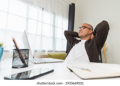 Young Asian Businessman Finish The Job Turn Off Laptop And Take A Rest. Indian Freelancer Finished His Work And Take A Break. He Work At Home.