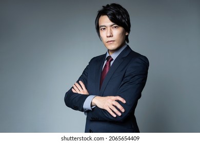 Young Asian Businessman Folding Arms.