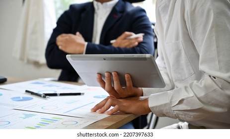 A Young Asian Businessman Or Male Marketing Worker Presents And Shares His Ideas With The Board Members In The Meeting. Cropped Image