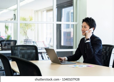 Young Asian Businessman In Office.