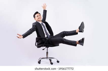 Young Asian Businessman Sitting On Chair On White Background