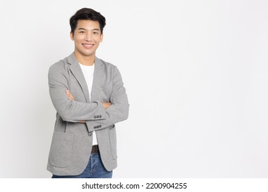 Young Asian businessman smilling with arms crossed isolated on white background - Shutterstock ID 2200904255