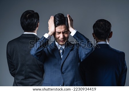 Young Asian businessman troubled between two bosses. relationship stress.