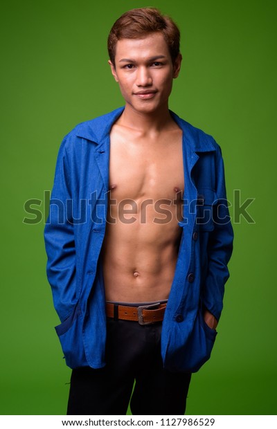 Young Asian businessman wearing blue shirt\
fully unbuttoned