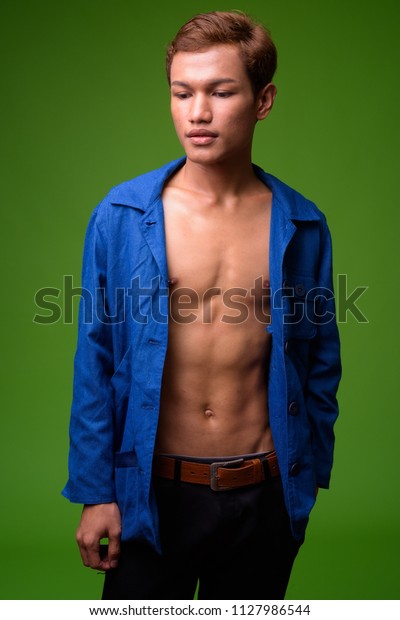 Young Asian businessman wearing blue shirt\
fully unbuttoned