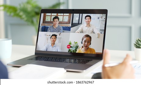 Young Asian Businessman Work At Home And Virtual Video Conference Meeting With Colleagues Business People, Online Working, Video Call At Home Office