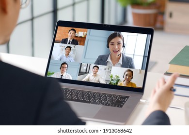 Young Asian Businessman Work At Home And Virtual Video Conference Meeting With Colleagues Business People, Online Working, Video Call At Home Office